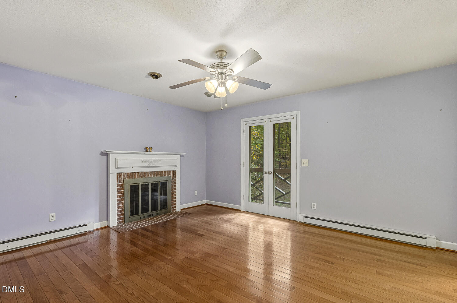 120 Elf Way Pittsboro, NC 27312 - Photo 16 of 68 an empty room with windows fireplace and a wooden floor
