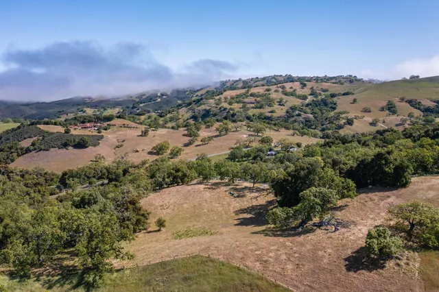 an aerial view of a houses with a yard