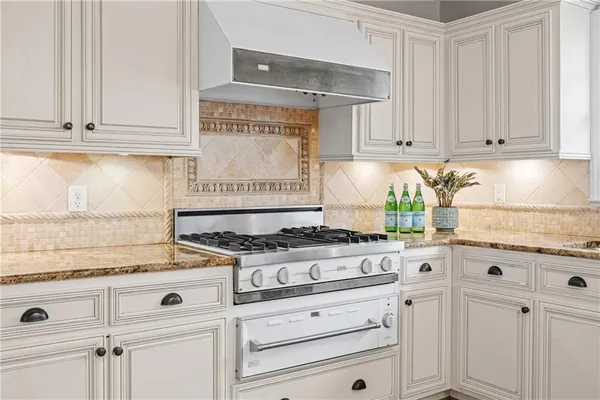 a kitchen with a sink cabinets and a stove top oven
