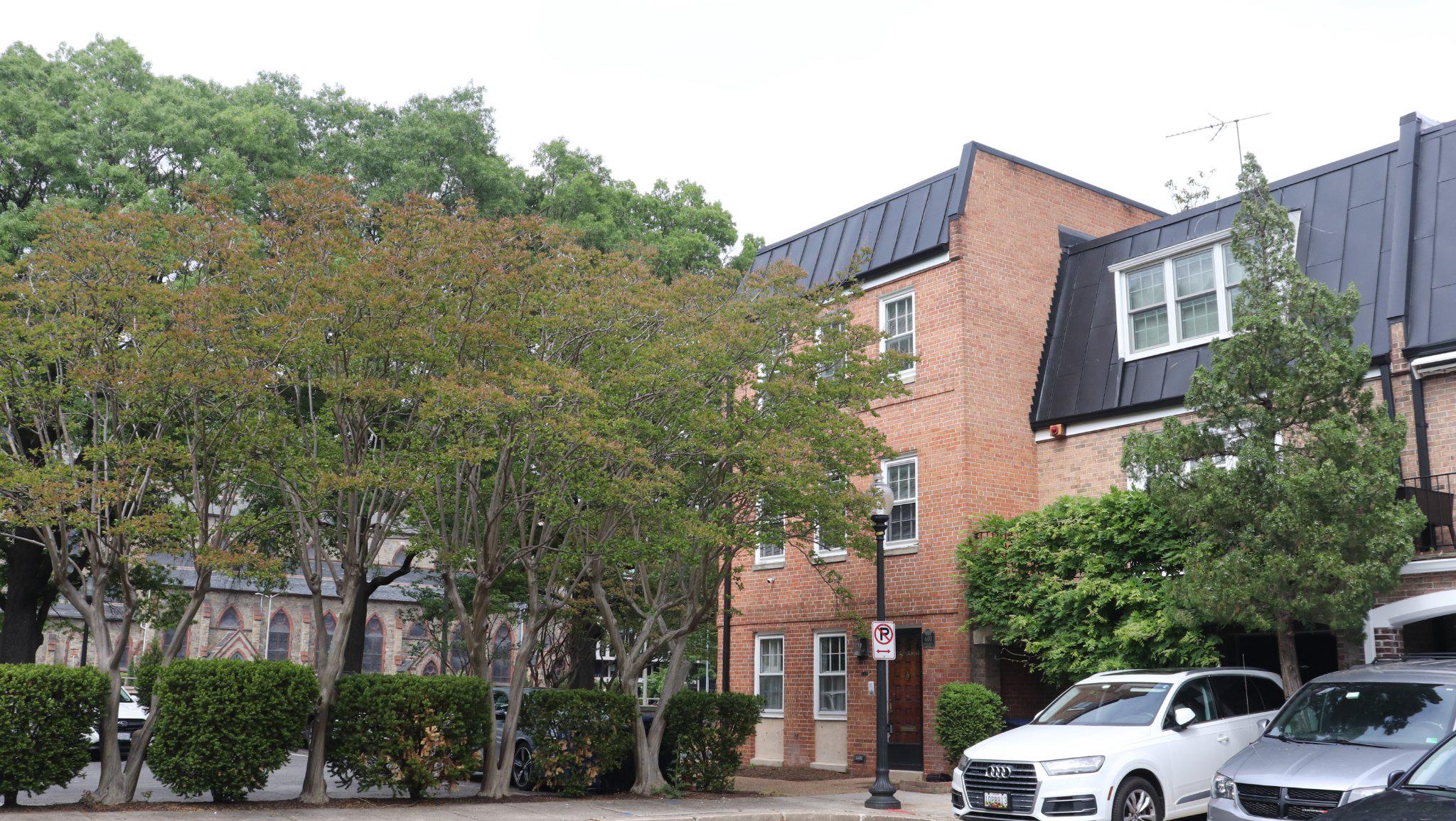 a front view of a building with trees