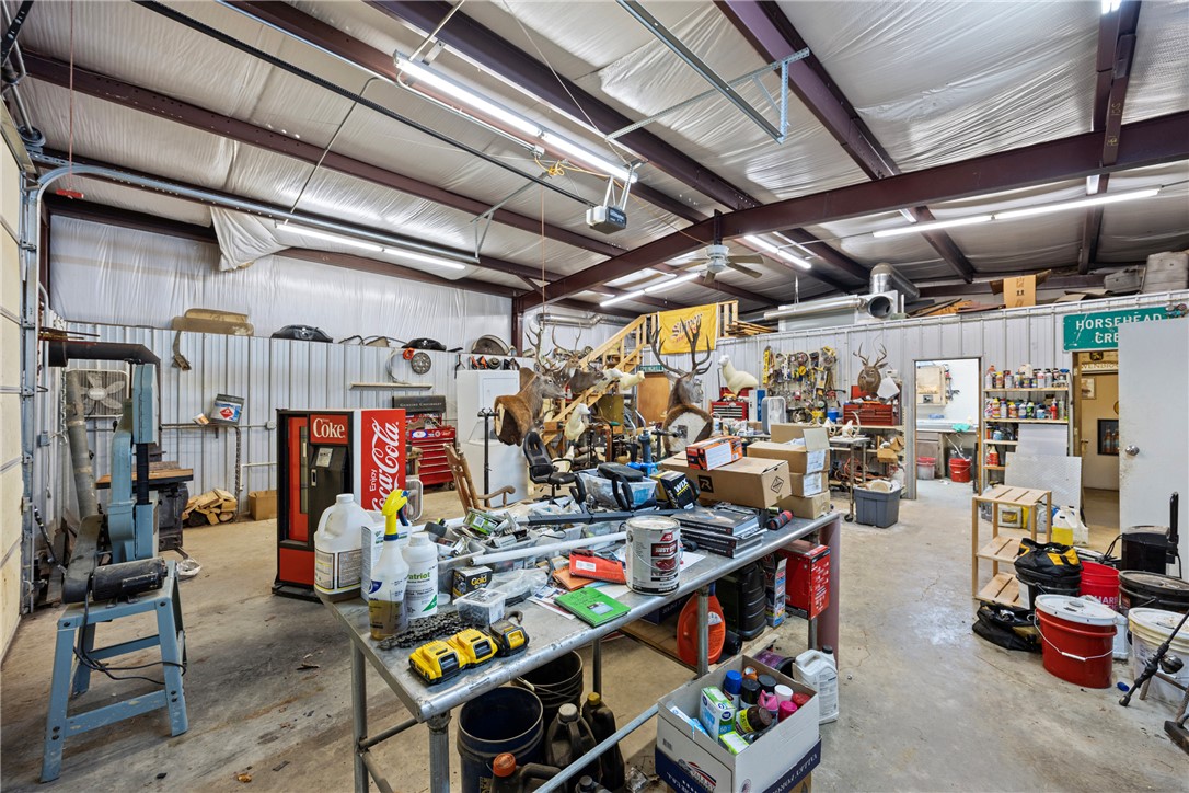 655 Charton Road Morrilton, AR 72110 - Photo 30 of 49 Spacious interior workshop with exposed steel beams and corrugated metal walls