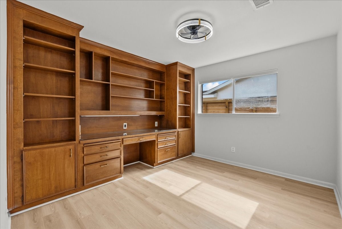 5762 Birdwood Road Houston, TX 77096 - Photo 23 of 50 BEDROOM #4 WITH SOLID WOOD BUILT IN CABINETRY CAN BE USED AS A STUDY FOR WORK FROM HOME, PERSONAL LIBRARY, OR BEDROOM.