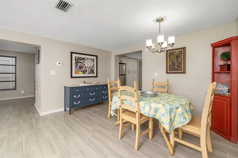 a kitchen with a sink dishwasher and white cabinets with wooden floor