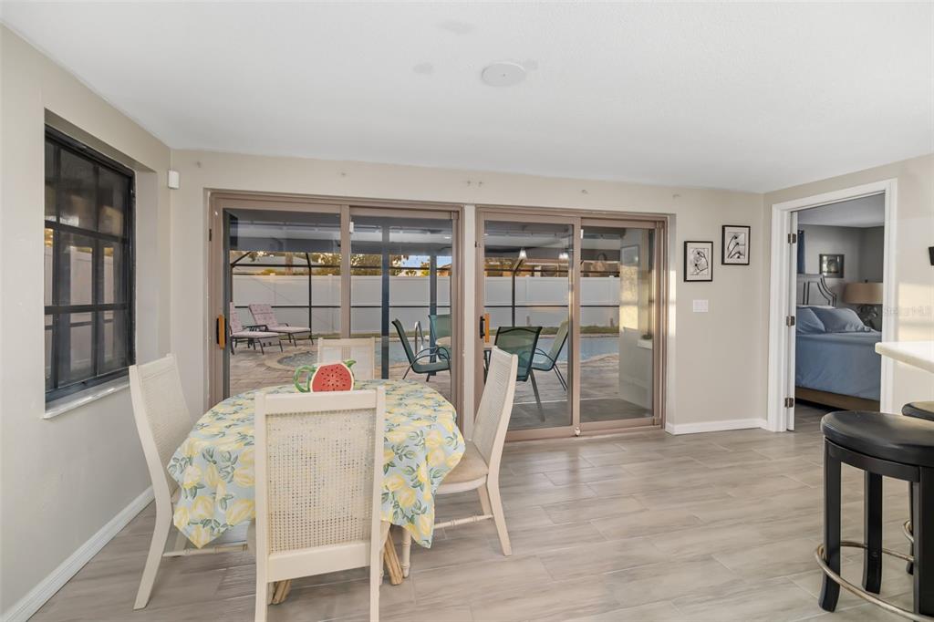 410 Pameto Road Nokomis, FL 34275 - Photo 16 of 40 a dining room with furniture and wooden floor