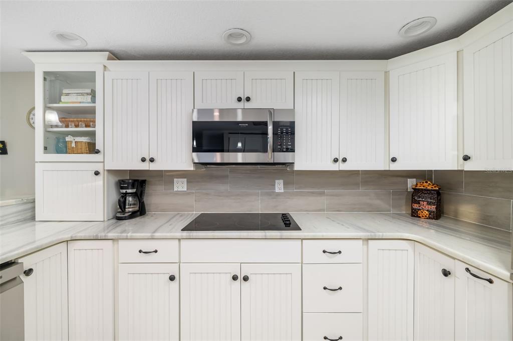 410 Pameto Road Nokomis, FL 34275 - Photo 17 of 40 a kitchen with white cabinets and white appliances