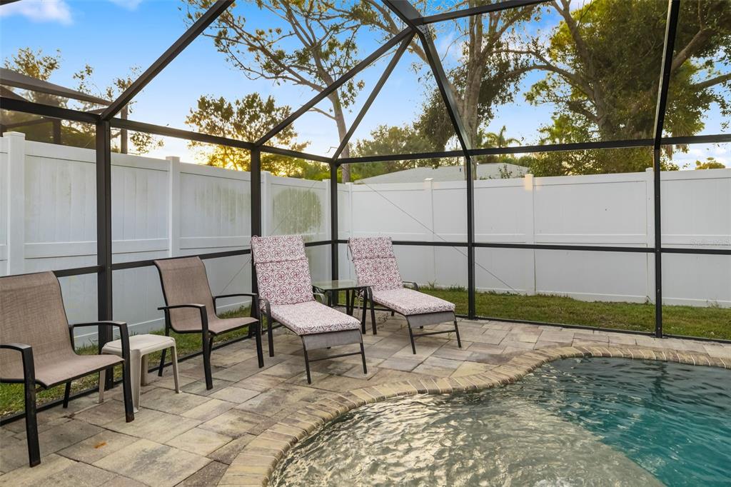 410 Pameto Road Nokomis, FL 34275 - Photo 22 of 40 a view of chairs and bench in the yard