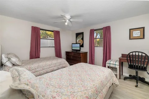 a bedroom with a bed and a chair