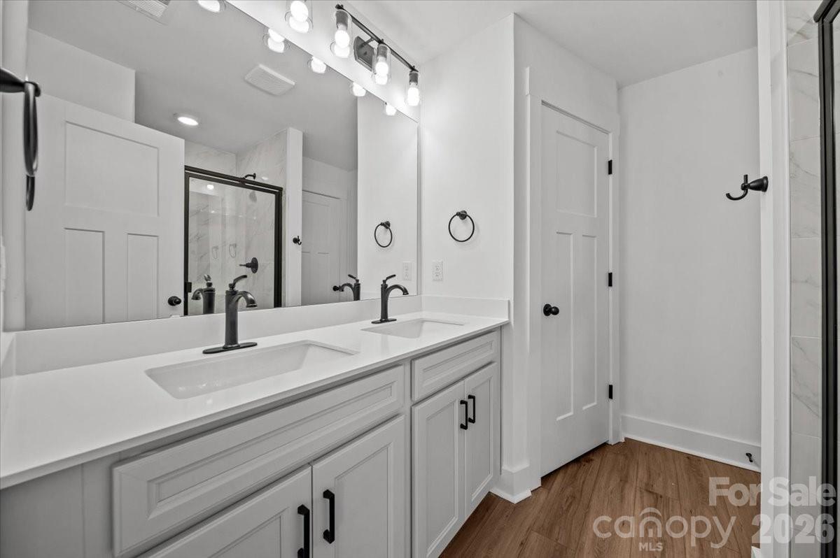 49 Moon Hvn Way Arden, NC 28704 - Photo 16 of 30 a bathroom with a sink a light fixture and a mirror