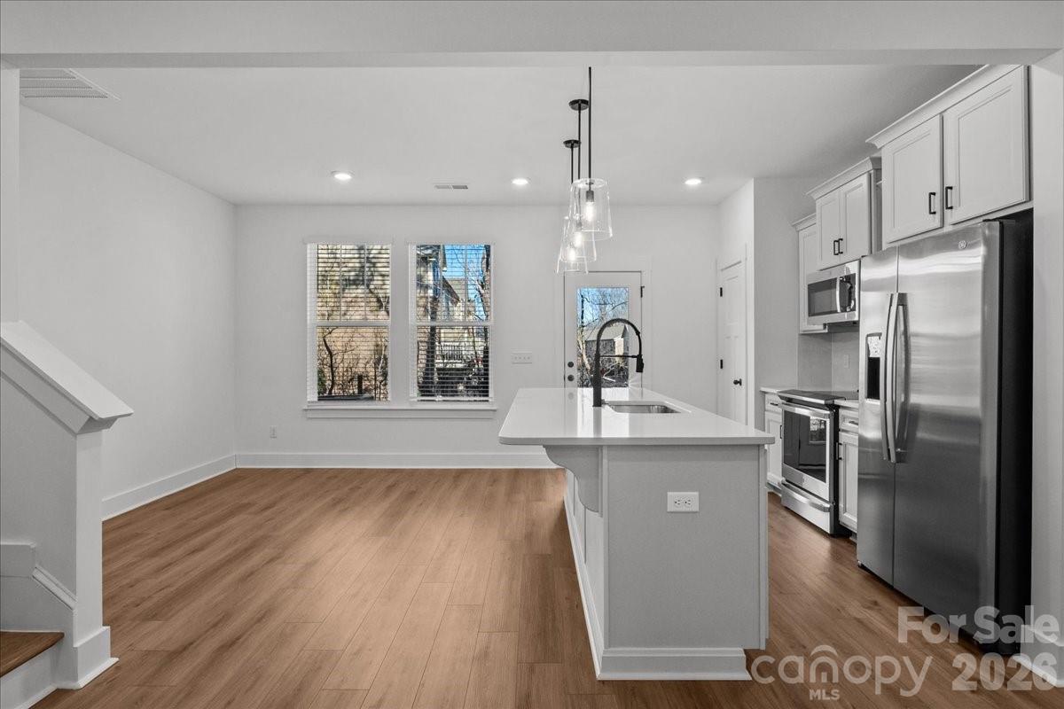 49 Moon Hvn Way Arden, NC 28704 - Photo 5 of 30 a view of a kitchen with stainless steel appliances granite countertop a refrigerator a stove a sink and a wooden floors