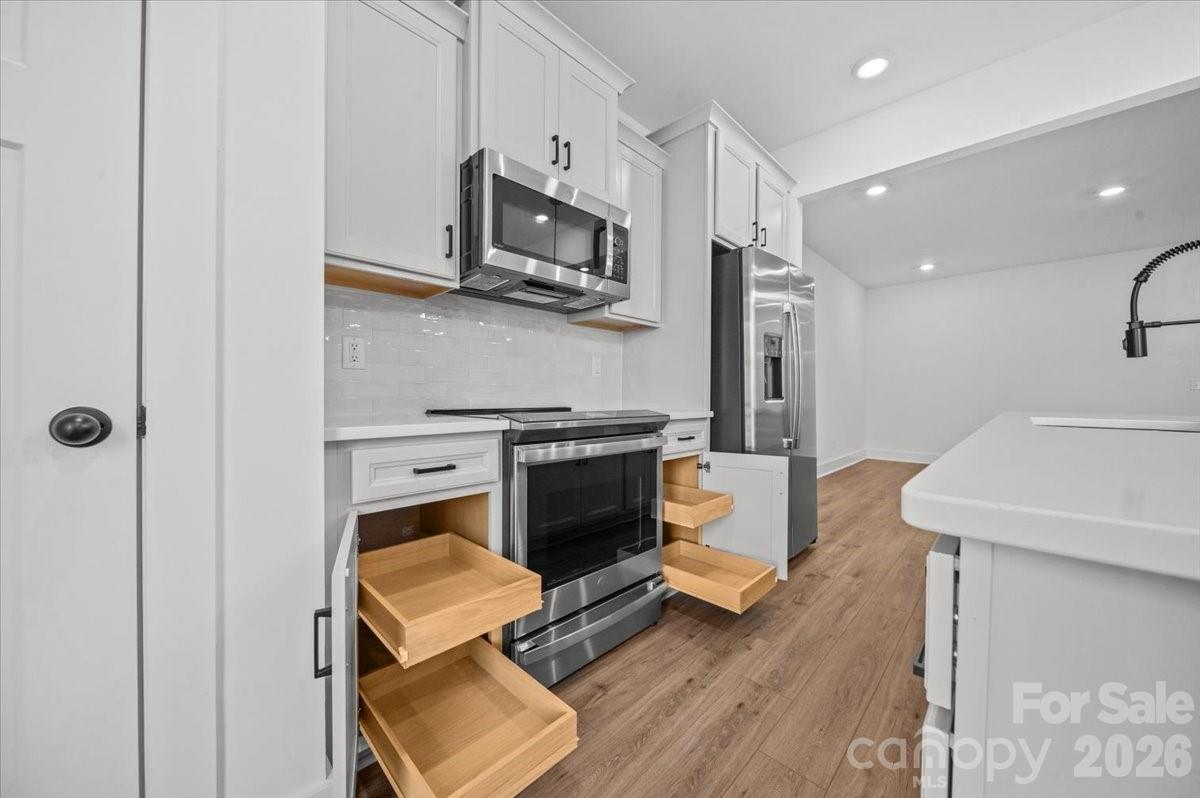 49 Moon Hvn Way Arden, NC 28704 - Photo 6 of 30 a kitchen with a sink a microwave a refrigerator and cabinets