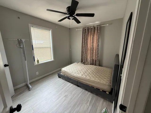 a bedroom with a bed and a window