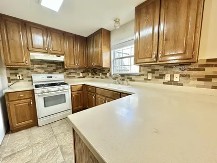a kitchen with a refrigerator stove and sink