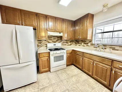 a kitchen with a stove and white cabinets