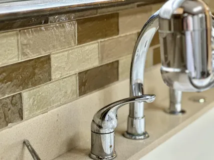 a kitchen with granite countertop a sink and a stove