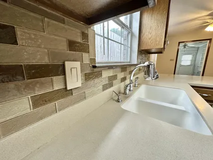 a kitchen with granite countertop a sink and a window