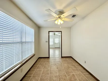 a dining room with furniture and window
