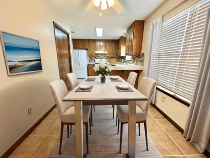 a spacious bedroom with a bed and a chandelier