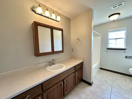 a bathroom with a sink a vanity and a mirror
