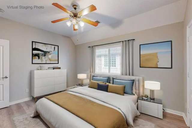 a bedroom with a bed and a painting on the wall