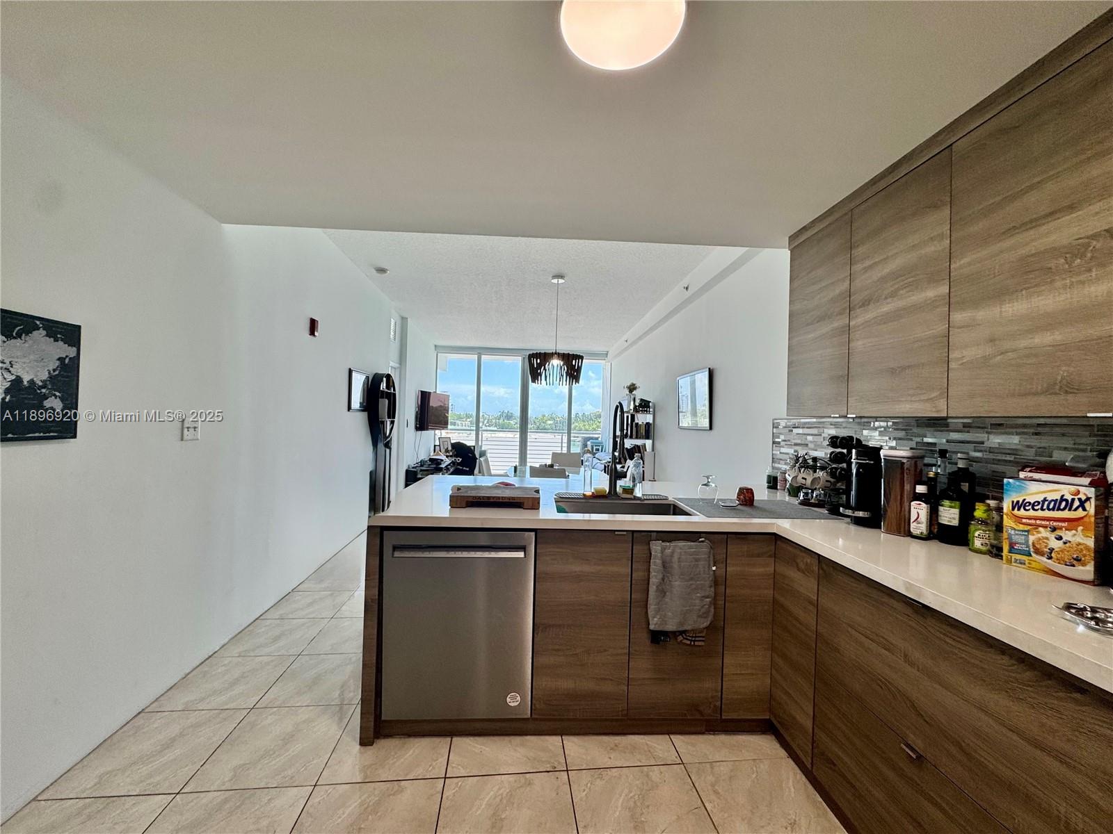 6580 Indian Creek Drive, Unit 404 Miami Beach, FL 33141 - Photo 14 of 19 a kitchen with a sink and cabinets