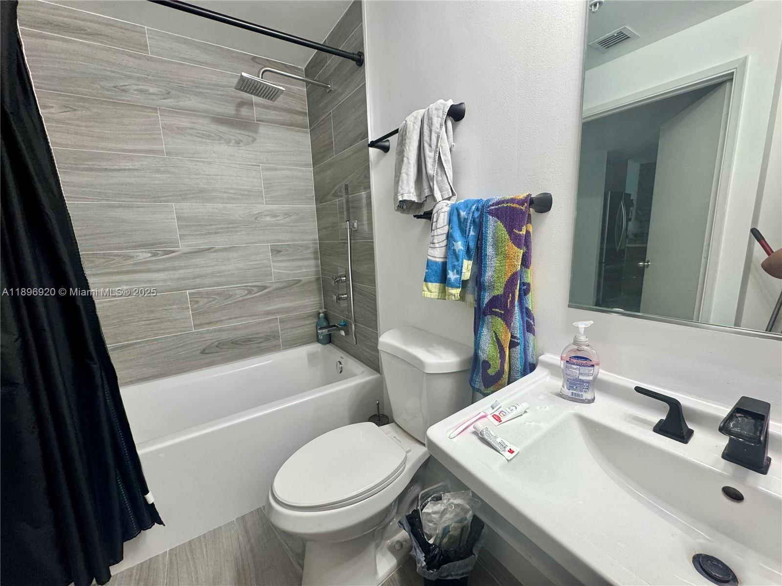 6580 Indian Creek Drive, Unit 404 Miami Beach, FL 33141 - Photo 15 of 19 a bathroom with a sink toilet and shower