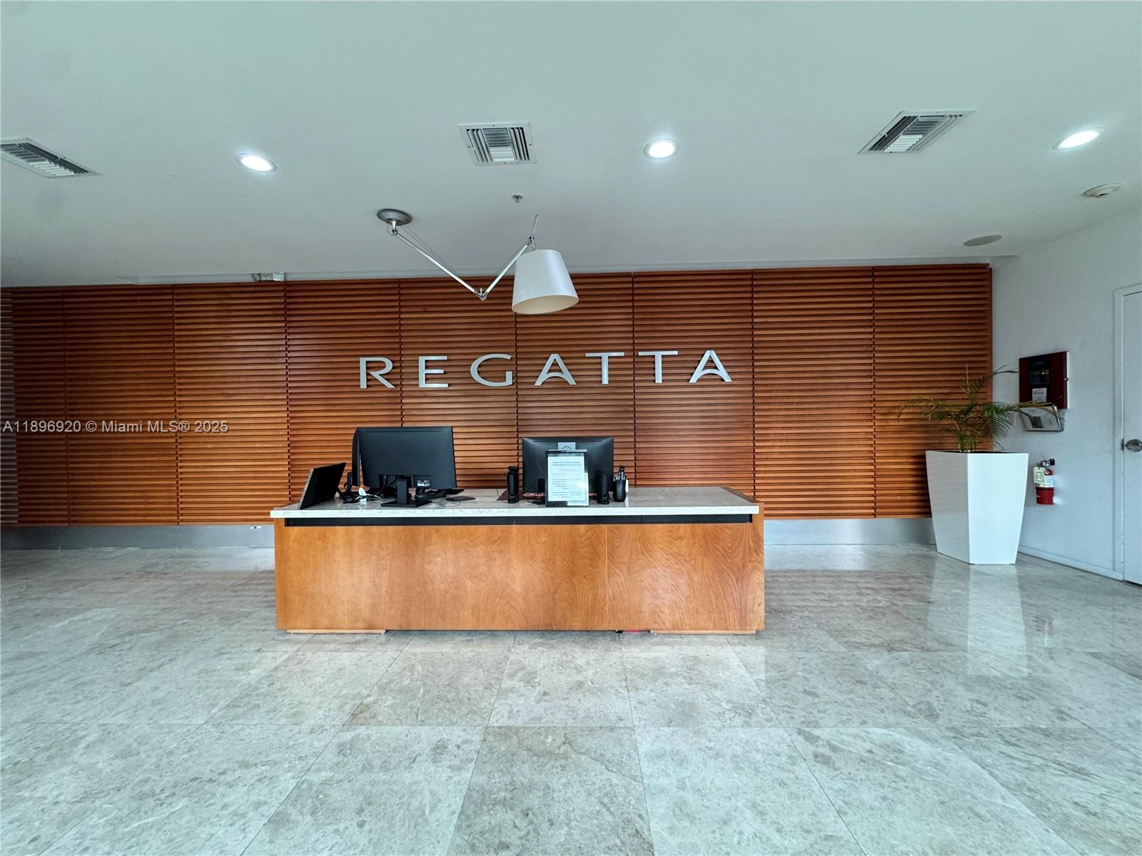 6580 Indian Creek Drive, Unit 404 Miami Beach, FL 33141 - Photo 18 of 19 a room with stainless steel appliances wooden cabinets and a counter top space