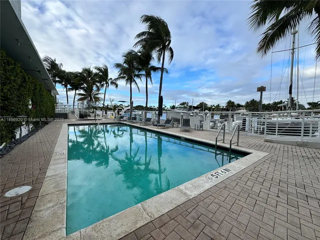 a view of swimming pool with a table and chairs