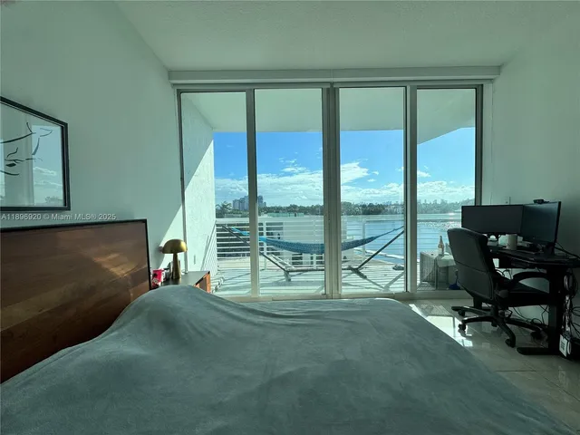 a living room filled with furniture and a floor to ceiling window