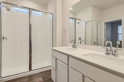 709 Iron Brg Road Georgetown, TX 78626 - Photo 8 of 11 Dual vanities and a spacious shower elevate daily routines in this well-appointed bathroom.