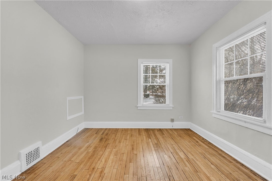 3318 Milverton Road, Unit 1/DN Shaker Heights, OH 44120 - Photo 16 of 21 This room features hardwood floors, light-colored walls, and two windows providing natural light