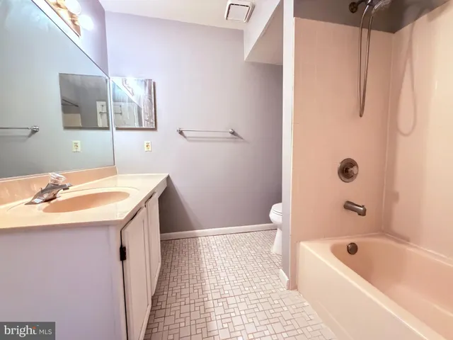 a bathroom with a sink a toilet a shower curtain and a bath tub