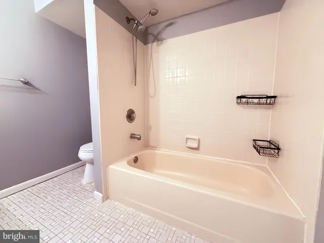 a white bath tub sitting next to a white toilet