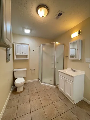 a spacious bathroom with a toilet sink and a mirror