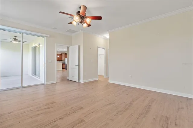 a view of an empty room with wooden floor