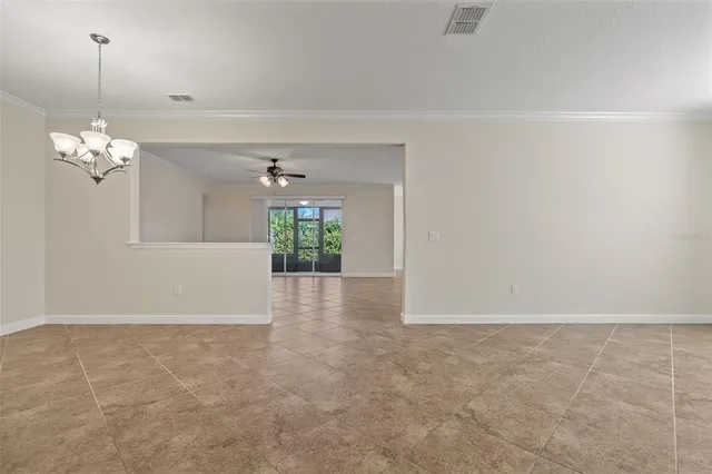 a view of a livingroom with a chandelier fan