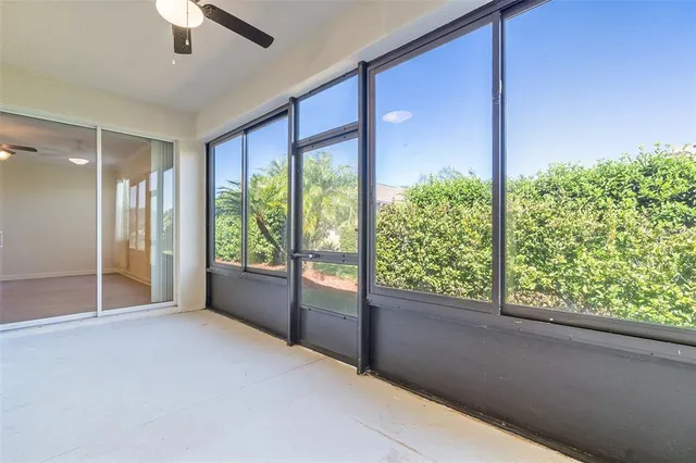 an empty room with fan and entrance