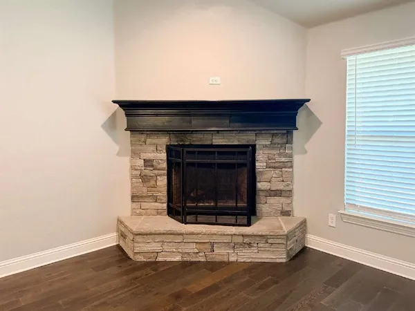 a living room with a fireplace and a wooden floor