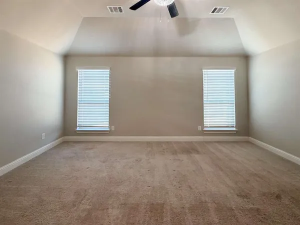 an empty room with windows and closet