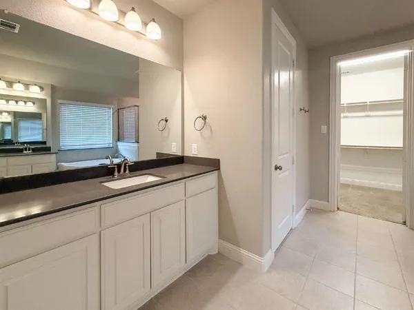 a bathroom with double sink and a mirror