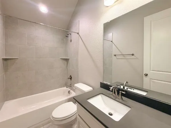 a bathroom with a sink a toilet and a bathtub