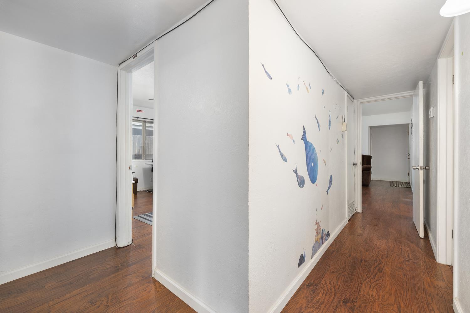 4683 North Angus Street Fresno, CA 93726 - Photo 15 of 27 a view of a hallway with wooden floor and staircase