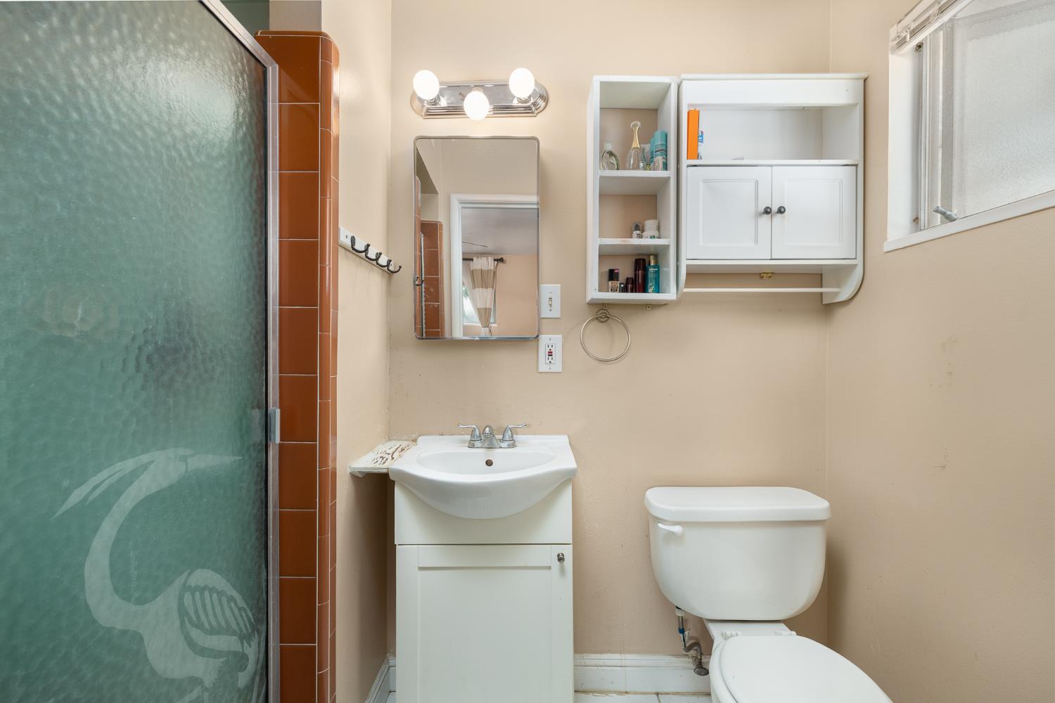4683 North Angus Street Fresno, CA 93726 - Photo 19 of 27 a bathroom with a toilet sink and mirror