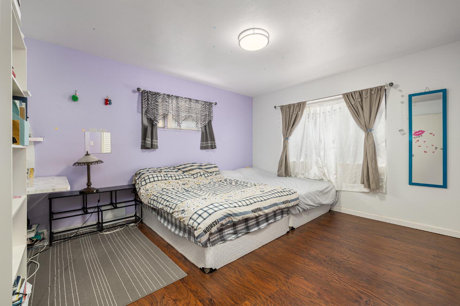 4683 North Angus Street Fresno, CA 93726 - Photo 20 of 27 a bedroom with a bed lamp closet and window