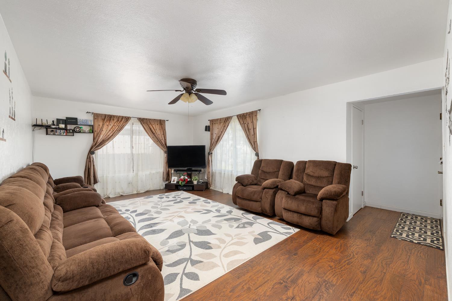 4683 North Angus Street Fresno, CA 93726 - Photo 5 of 27 a living room with furniture and a wooden floor