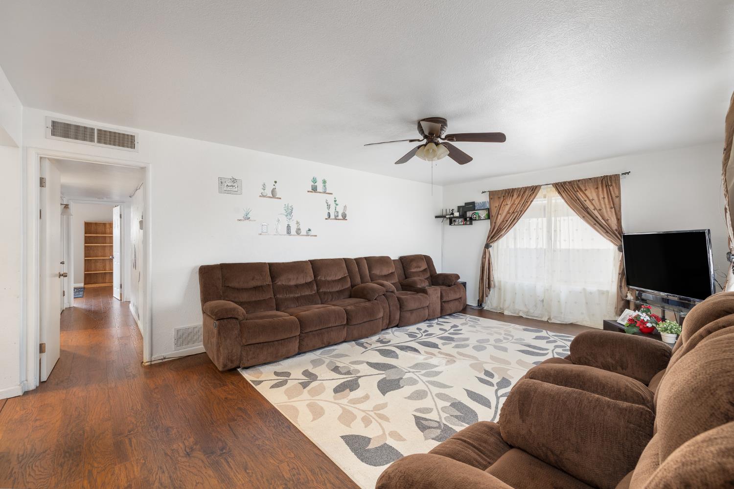 4683 North Angus Street Fresno, CA 93726 - Photo 6 of 27 a living room with a couch and a flat screen tv