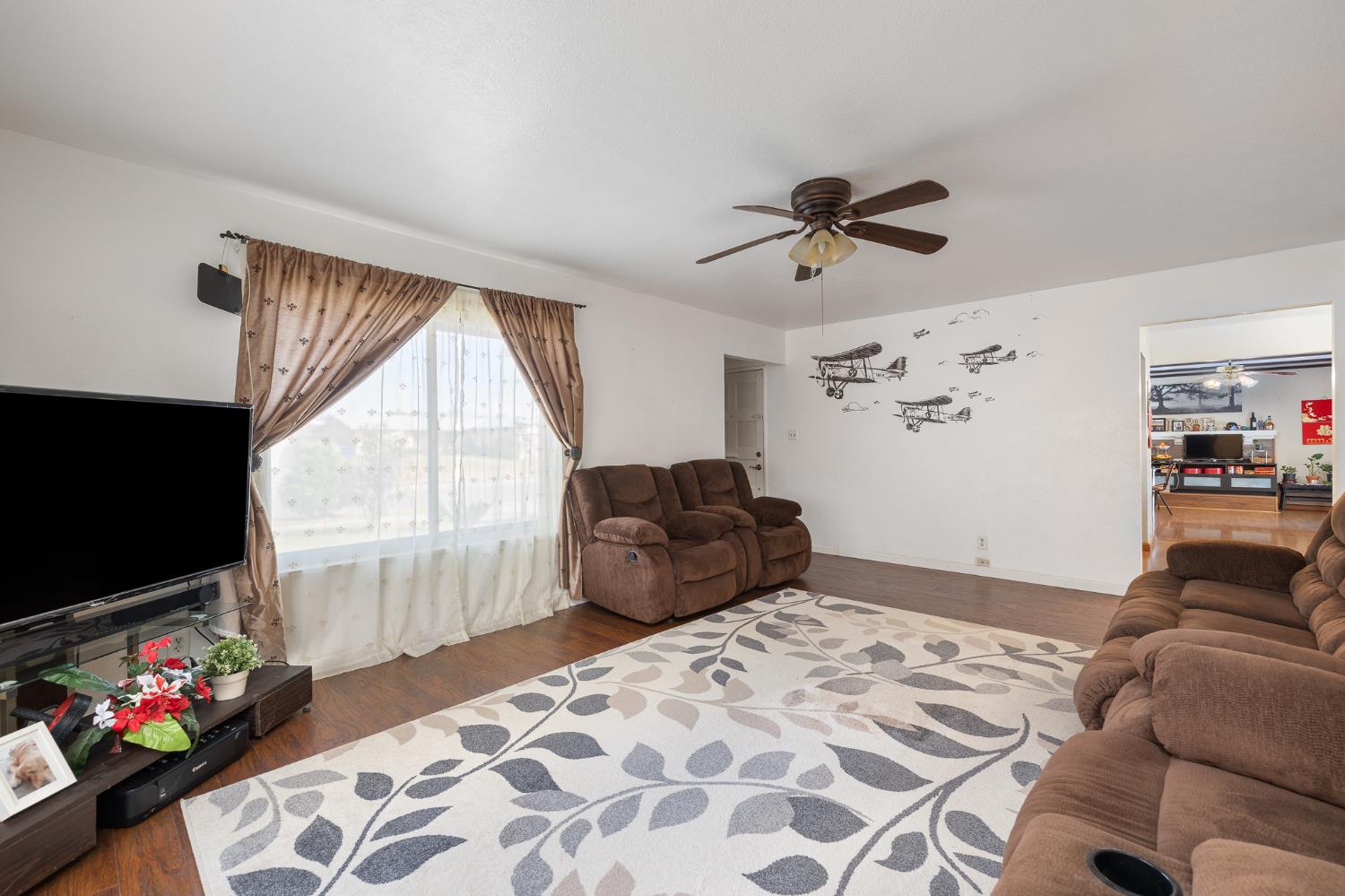 4683 North Angus Street Fresno, CA 93726 - Photo 7 of 27 a bedroom with furniture and a flat screen tv