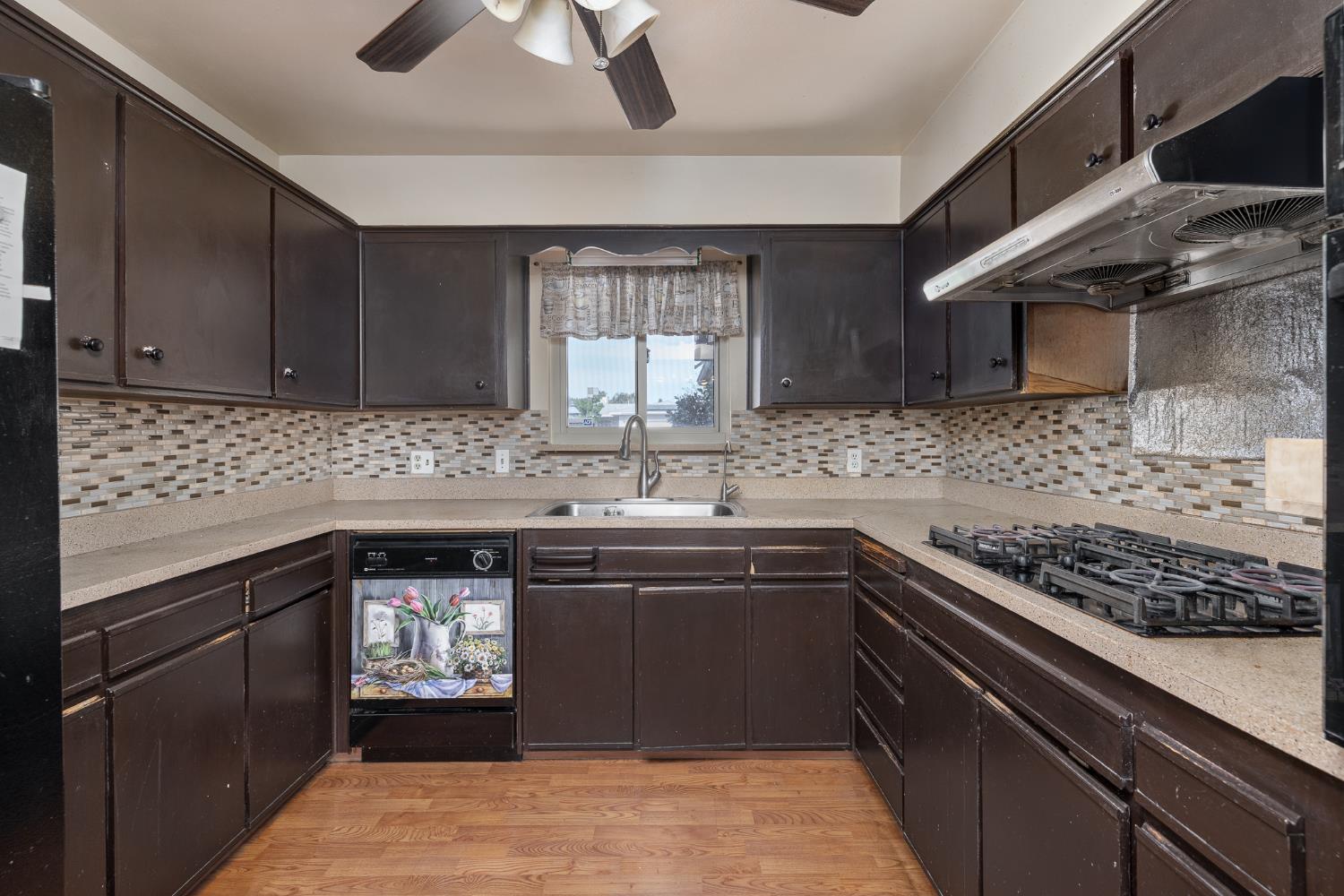 4683 North Angus Street Fresno, CA 93726 - Photo 10 of 27 a kitchen with stainless steel appliances granite countertop a sink stove and cabinets