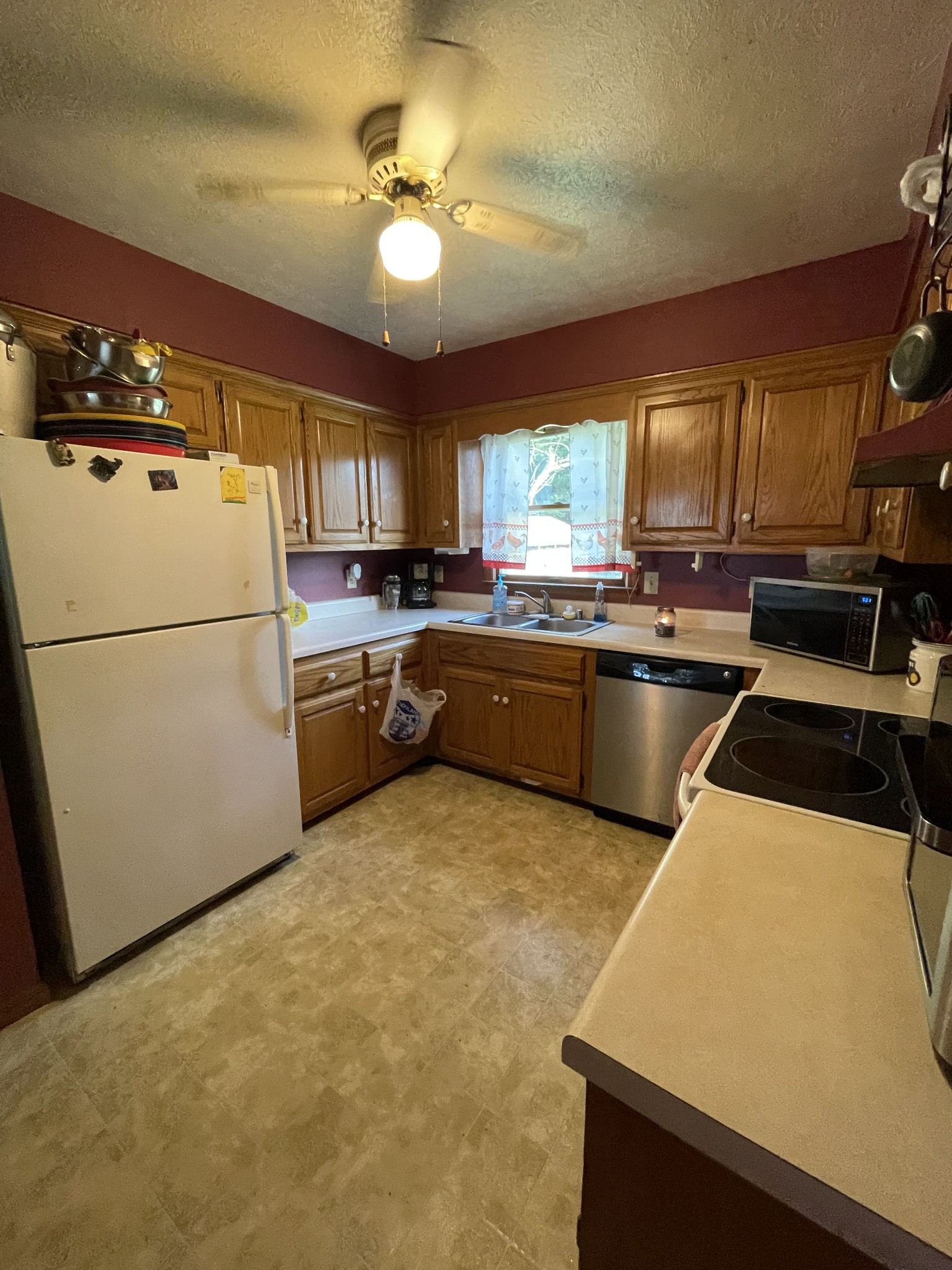 588 Gregory Road Westmoreland, TN 37186 - Photo 10 of 11 a kitchen with a refrigerator a stove a sink and a refrigerator