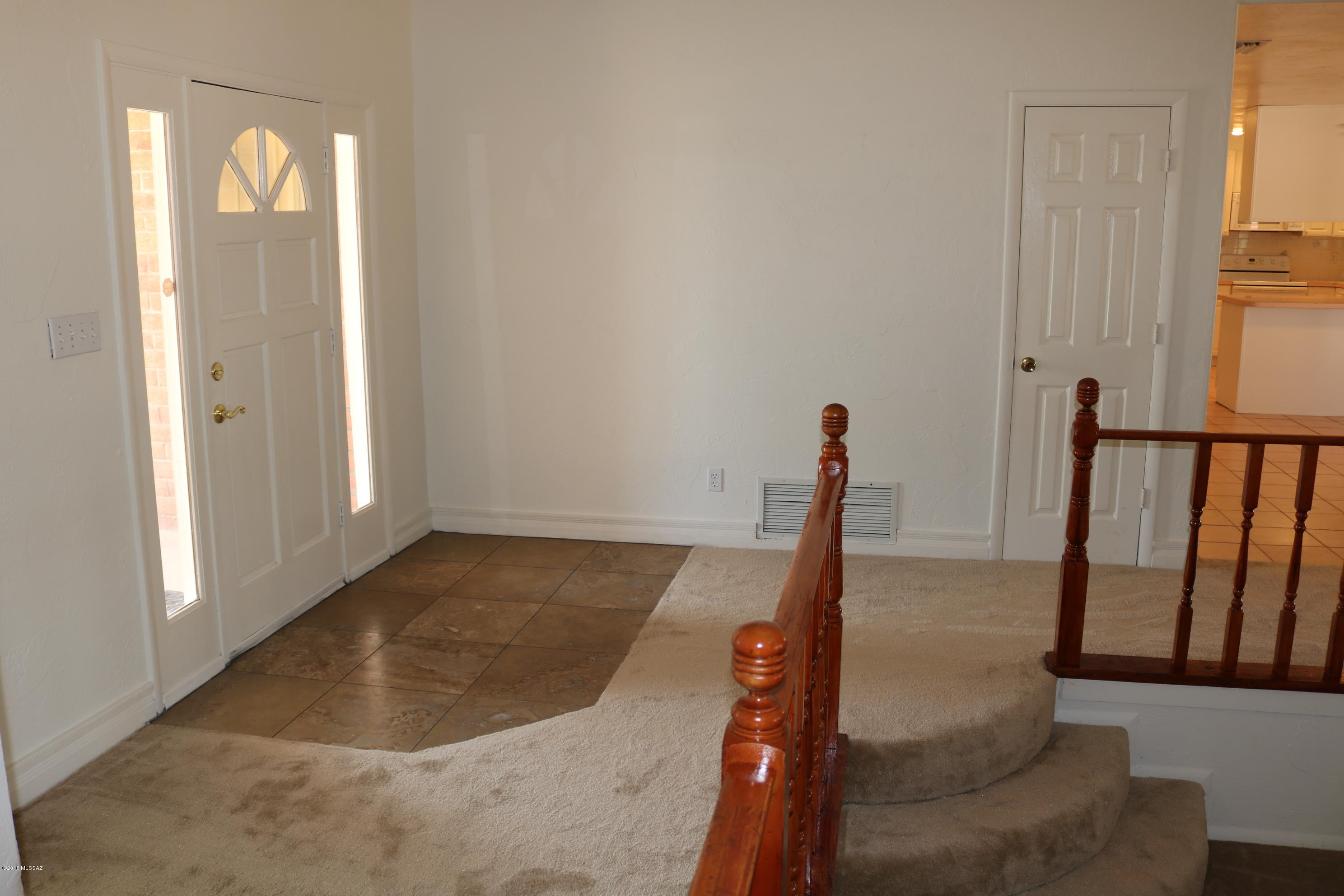 5851 South Avra Road Tucson, AZ 85735 - Photo 13 of 46 a view of a hallway with white walls and stairs