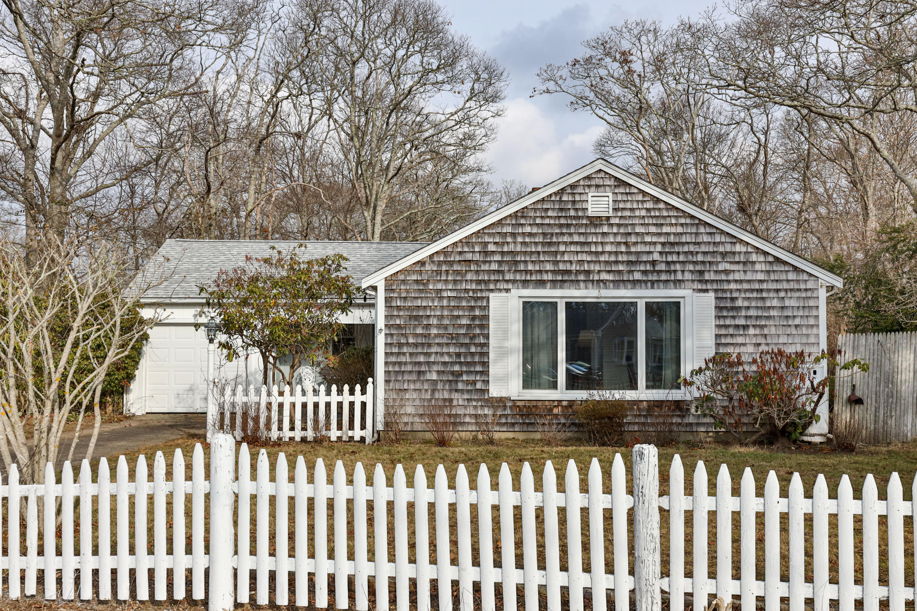 a front view of a house with a garden